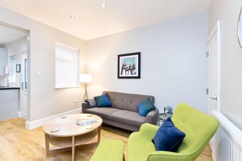 Bright, modern living room with a comfortable g...