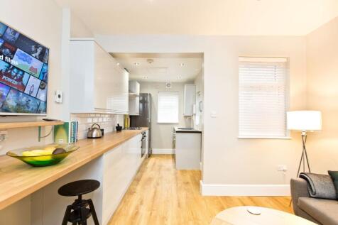 Bright and modern kitchen featuring a wooden co...