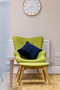 A bright and stylish living room featuring a vi...