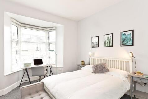 Bright, contemporary master bedroom with a larg...