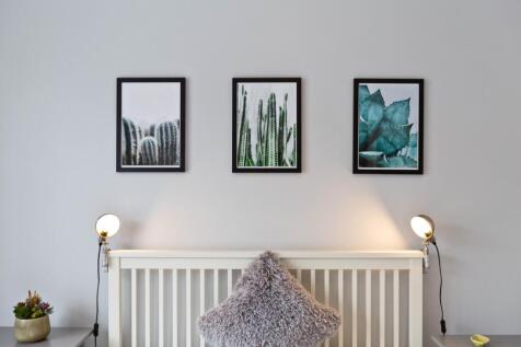 A cozy bedroom featuring a stylish headboard wi...