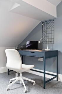 Bright angled workspace with a modern navy desk...