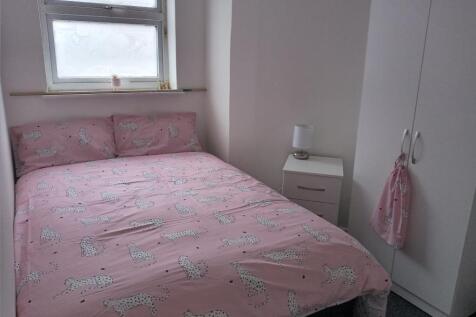 Cozy double bedroom featuring a pink cheetah pr...