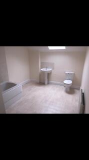 Spacious bathroom featuring a comfortable batht...