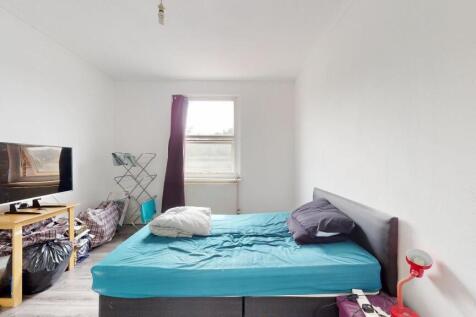 A bright, minimalist living space featuring a b...