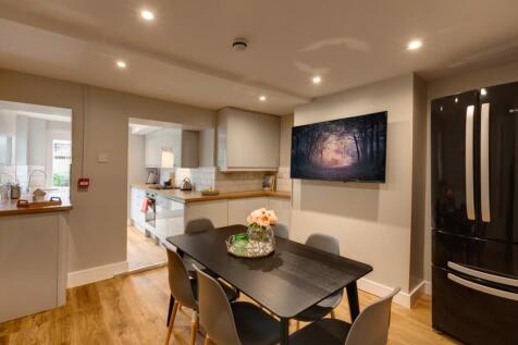 A modern, well-lit living room with a comfortab...