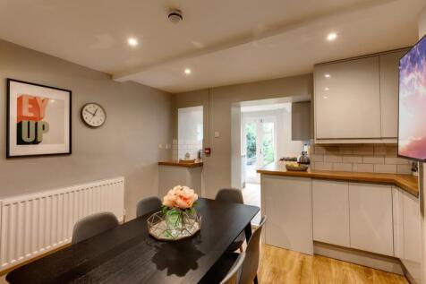 Stylish open-plan kitchen diner with a dark woo...