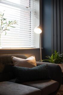 A cozy living room featuring a comfortable sofa...