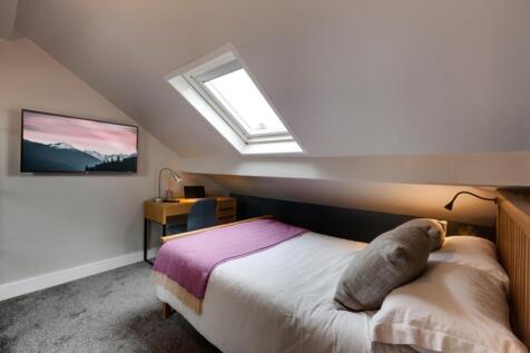 A bright and inviting master bedroom featuring ...