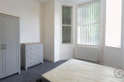 Bright and welcoming bedroom with large windows...