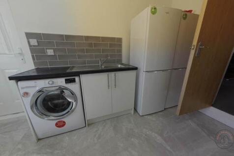 A modern kitchen area featuring essential appli...