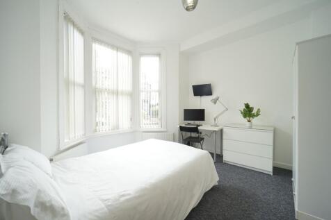 Bright and airy bedroom with large windows offe...
