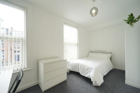 Bright and welcoming double bedroom featuring a...