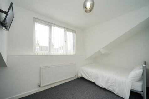 A bright and clean bedroom featuring a double b...