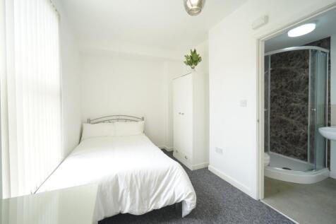 A bright, tidy bedroom with a comfortable doubl...