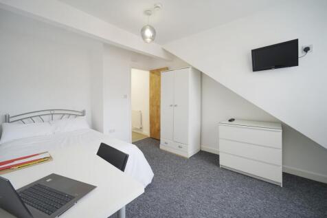 Bright and spacious master bedroom featuring a ...