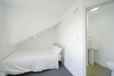A clean and bright bathroom with a sink and toi...