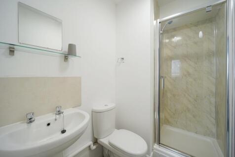 A clean and modern bathroom featuring a large s...