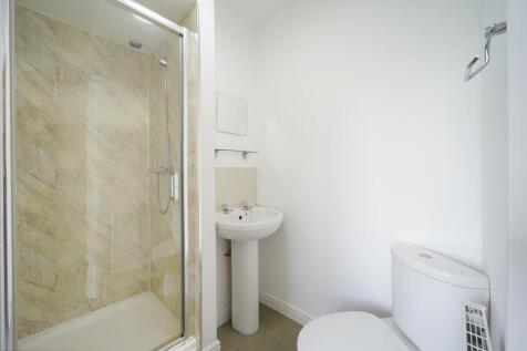 A clean and modern bathroom featuring a shower ...