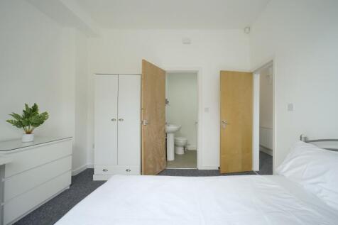 Bright and clean bathroom suite featuring a spa...