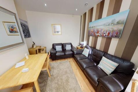 A spacious and well-lit contemporary living roo...