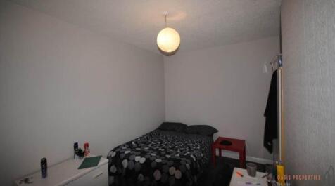 A cozy bedroom featuring a double bed with a bl...