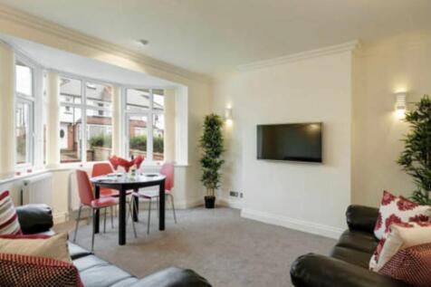 A bright and spacious living room featuring lar...