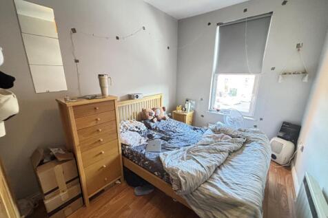 A bright and spacious master bedroom featuring ...