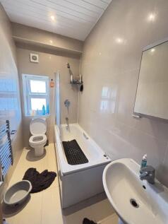 Clean and modern bathroom featuring a bathtub, ...