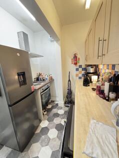 A compact kitchen with modern appliances and a ...