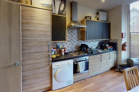 A bright and modern kitchen featuring ample wor...