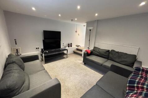 A spacious and modern living room featuring com...