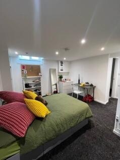 A spacious and well-maintained bedroom featurin...