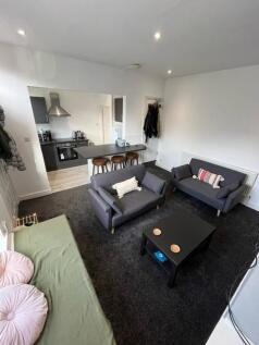 A modern and welcoming living room featuring tw...