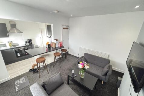 A spacious and welcoming living room featuring ...