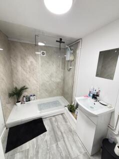 A modern, clean bathroom featuring a spacious s...