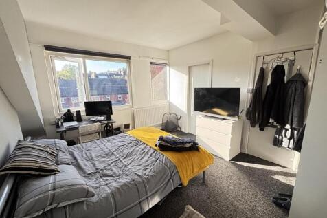 A bright, well-maintained bedroom featuring a d...