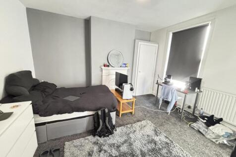 A cozy bedroom featuring a double bed, a wardro...