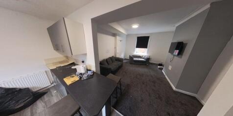 A spacious and well-lit living room with contem...