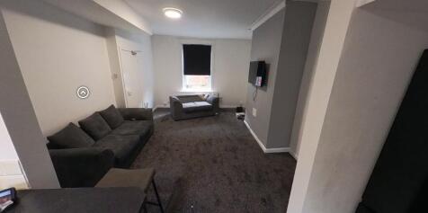 A contemporary and well-lit living room featuri...