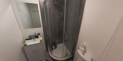 A clean and modern bathroom with a shower enclo...