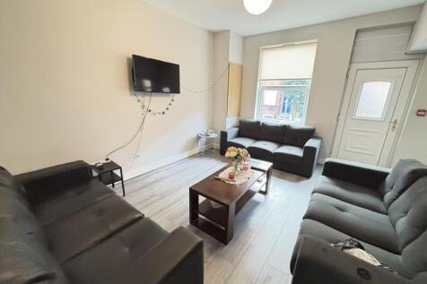 A bright and inviting living room featuring com...