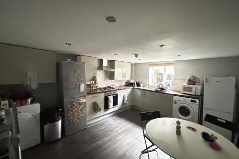 A modern and well-lit kitchen featuring applian...