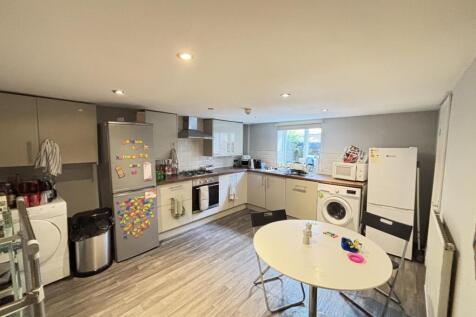 A modern, well-lit kitchen with ample counter s...