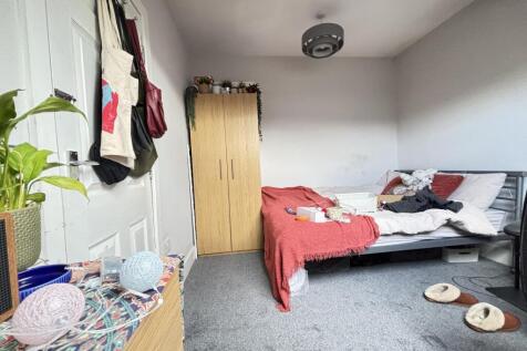 A cozy bedroom featuring a double bed with bedd...