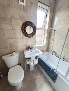 Bright and well-maintained bathroom featuring a...