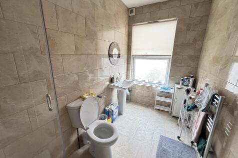 A spacious bathroom featuring a large white toi...
