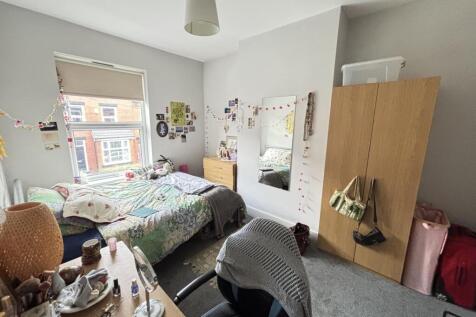 A cozy bedroom with a double bed and various pe...