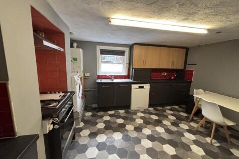 A well-maintained kitchen with modern cabinets,...