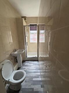 A clean and bright bathroom with a toilet, sink...